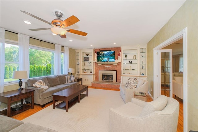 5 Haywood St, Staten Island, NY 10307 - living room with a ceiling fan, light wood-style floors, a brick fireplace, and built in shelves