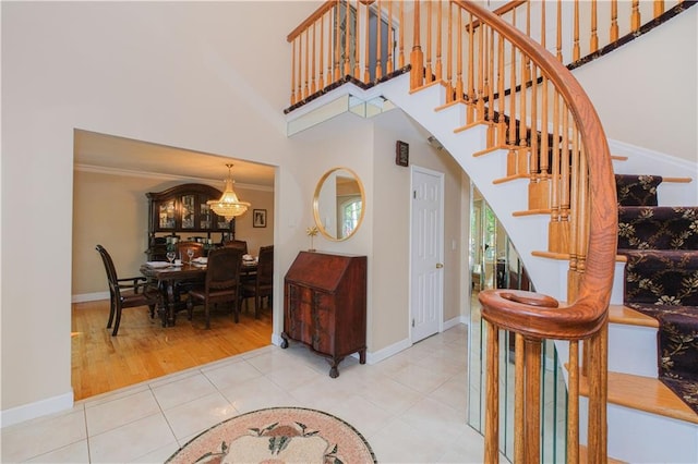 5 Haywood St, Staten Island, NY 10307 - entryway featuring stairway, a high ceiling, tile patterned flooring, baseboards, and a chandelier