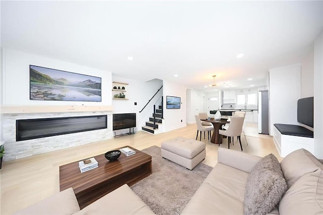542 Golfview Ct Unit 1, Staten Island, NY 10314 - living room featuring stairway, a glass covered fireplace, recessed lighting, light wood-type flooring, and baseboards
