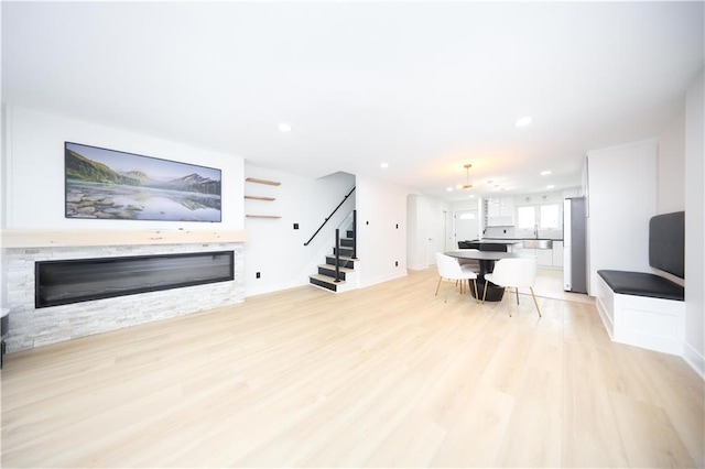 542 Golfview Ct Unit 1, Staten Island, NY 10314 - living room featuring a stone fireplace, stairs, light wood-style floors, recessed lighting, and baseboards