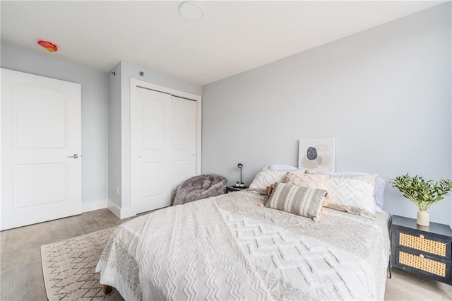 811 45th St Unit 5B, Brooklyn, NY 11220 - bedroom with wood finished floors, a closet, and baseboards