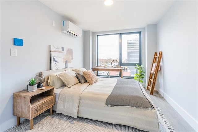 811 45th St Unit 5B, Brooklyn, NY 11220 - bedroom featuring a wall unit AC, baseboards, and wood finished floors