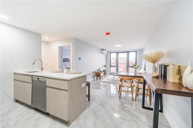 811 45th St Unit 5B, Brooklyn, NY 11220 - kitchen with stainless steel dishwasher, a sink, light marble finish flooring, modern cabinets, and light countertops