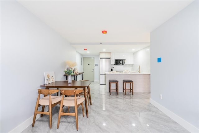 811 45th St Unit 5B, Brooklyn, NY 11220 - dining room featuring light marble finish floors and baseboards