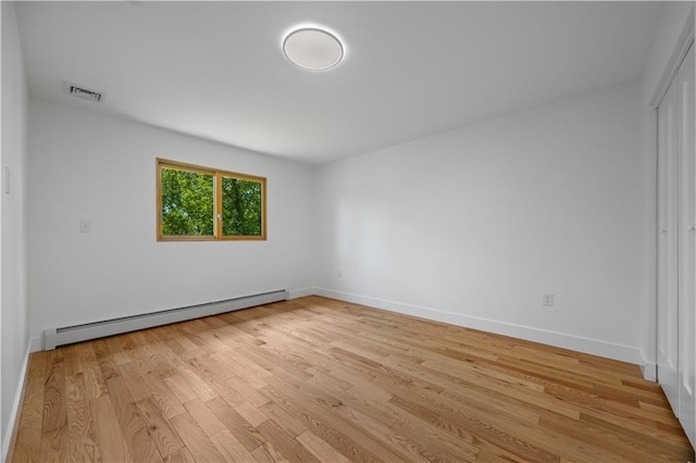 164 Railroad St, Staten Island, NY 10312 - unfurnished room featuring a baseboard radiator, light wood-style flooring, and baseboards