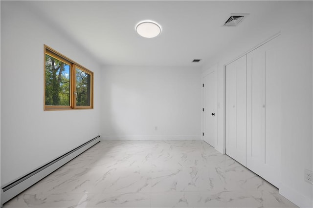 164 Railroad St, Staten Island, NY 10312 - unfurnished bedroom with baseboard heating, marble look tiles, baseboards, and a closet