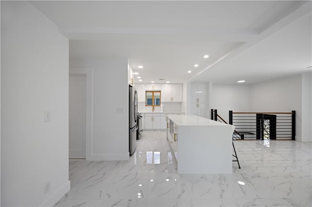 164 Railroad St, Staten Island, NY 10312 - kitchen with freestanding refrigerator, white cabinets, a kitchen island, recessed lighting, and baseboards