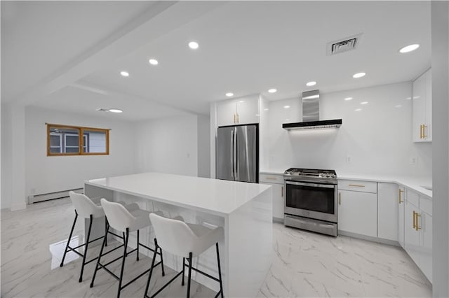 164 Railroad St, Staten Island, NY 10312 - kitchen with appliances with stainless steel finishes, wall chimney exhaust hood, baseboard heating, a breakfast bar area, and modern cabinets
