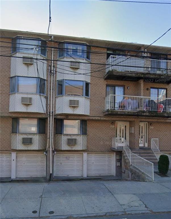 1072 E 73rd St Unit 93, Brooklyn, NY 11234 - view of apartment building / complex featuring driveway and a garage