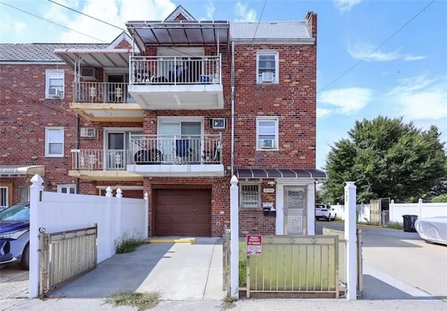 8784 24th Ave, Brooklyn, NY 11214 - view of property featuring brick siding, a garage, and driveway