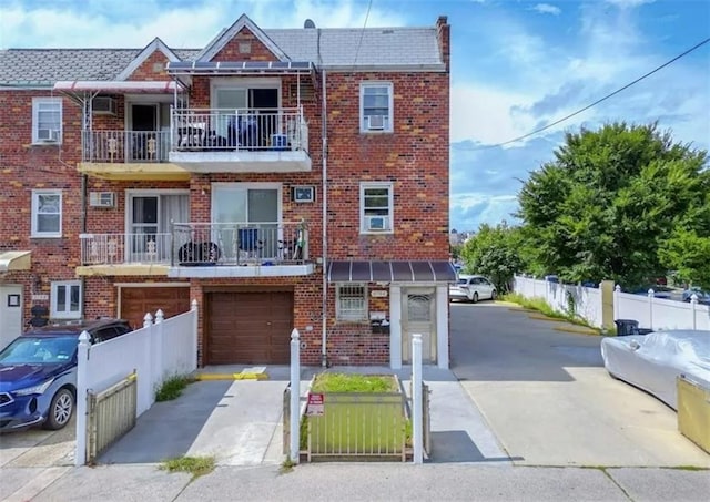 8784 24th Ave, Brooklyn, NY 11214 - view of front of house featuring driveway, brick siding, and a garage