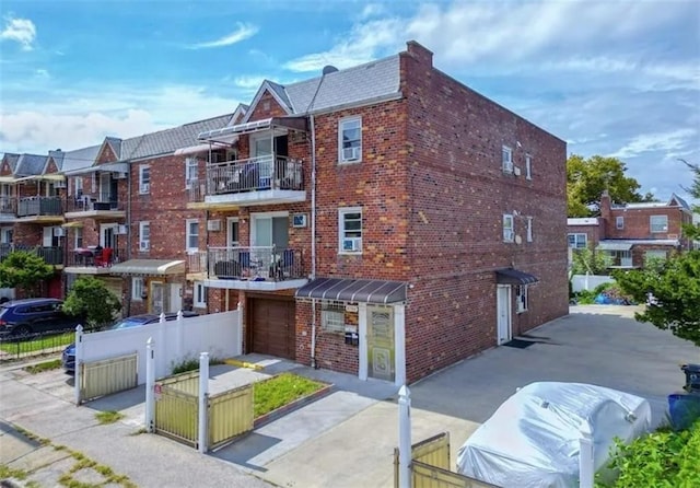 8784 24th Ave, Brooklyn, NY 11214 - view of building exterior featuring a garage