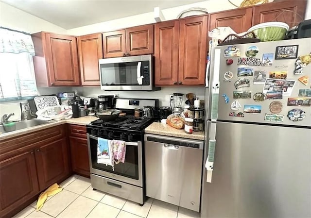 8784 24th Ave, Brooklyn, NY 11214 - kitchen with appliances with stainless steel finishes, light tile patterned floors, and light countertops