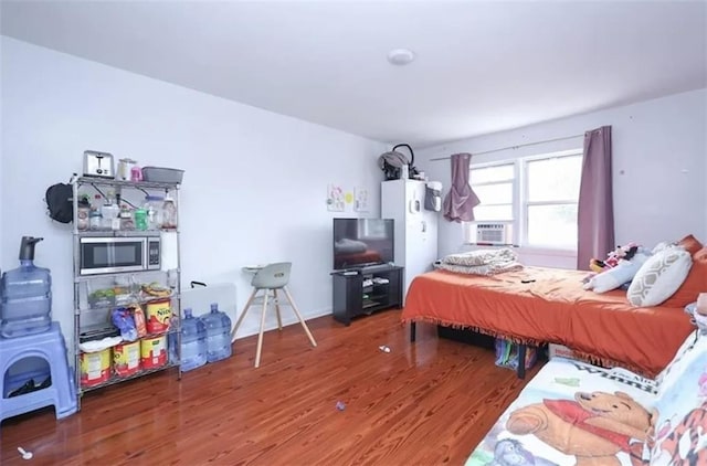 8784 24th Ave, Brooklyn, NY 11214 - bedroom with wood finished floors and cooling unit