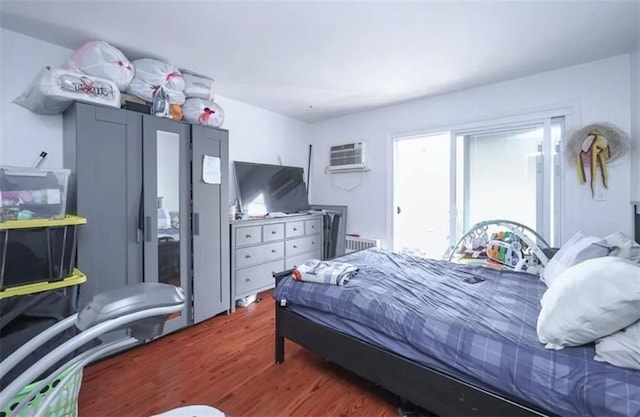 8784 24th Ave, Brooklyn, NY 11214 - bedroom featuring wood finished floors and a wall mounted air conditioner