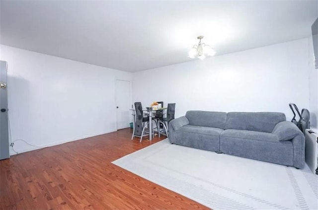 8784 24th Ave, Brooklyn, NY 11214 - living room featuring wood finished floors and a chandelier