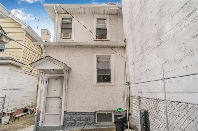1642 E 22nd St, Brooklyn, NY 11210 - doorway to property featuring stucco siding and cooling unit