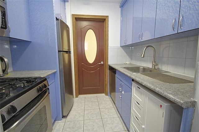 2299 E 13th St Unit 4E, Brooklyn, NY 11229 - kitchen featuring appliances with stainless steel finishes, decorative backsplash, light tile patterned flooring, and blue cabinetry