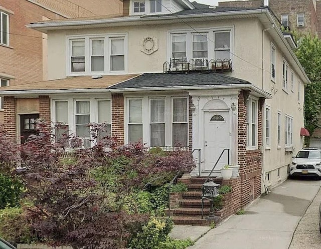 1745 E 21st St, Brooklyn, NY 11229 - view of front of house featuring stucco siding, brick siding, and a shingled roof
