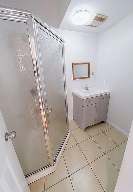 1745 E 21st St, Brooklyn, NY 11229 - bathroom with a stall shower, vanity, and tile patterned floors