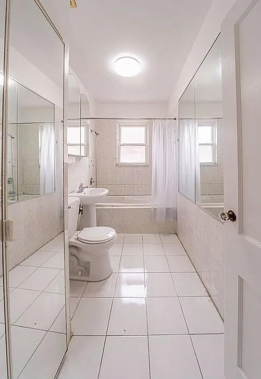 1745 E 21st St, Brooklyn, NY 11229 - full bathroom with tile patterned flooring, tiled shower / bath combo, and tile walls