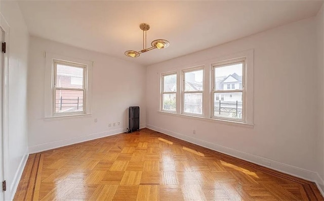 1745 E 21st St, Brooklyn, NY 11229 - unfurnished room with radiator heating unit, plenty of natural light, and a chandelier