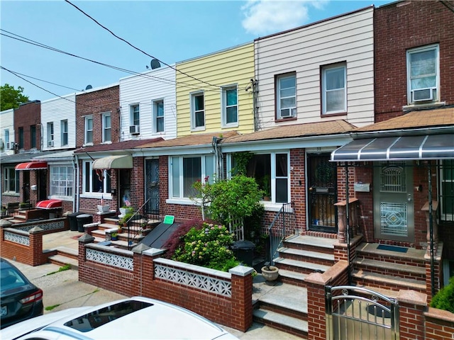 32 Gatling Pl, Brooklyn, NY 11209 - townhome / multi-family property with brick siding, a fenced front yard, entry steps, and cooling unit