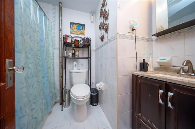 32 Gatling Pl, Brooklyn, NY 11209 - full bathroom with tile walls, vanity, tile patterned floors, a shower with curtain, and a wainscoted wall