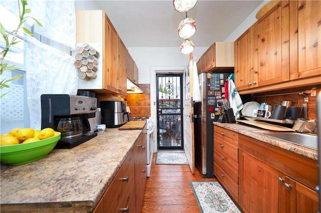 32 Gatling Pl, Brooklyn, NY 11209 - kitchen with decorative backsplash, freestanding refrigerator, dark wood-type flooring, brown cabinets, and light countertops