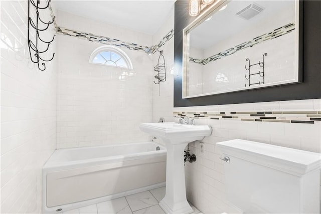 41 Bent St, Staten Island, NY 10312 - full bathroom with shower / washtub combination, marble look tiles, and tile walls