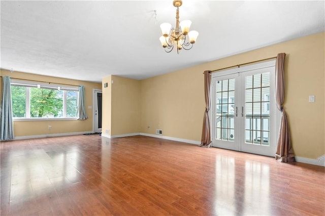 41 Bent St, Staten Island, NY 10312 - spare room featuring a chandelier, wood finished floors, and french doors