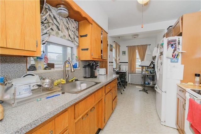 4070 Victory Blvd, Staten Island, NY 10314 - kitchen with white appliances, light countertops, radiator, backsplash, and brown cabinets