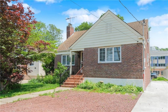 4070 Victory Blvd, Staten Island, NY 10314 - bungalow-style home with brick siding, a chimney, and a shingled roof