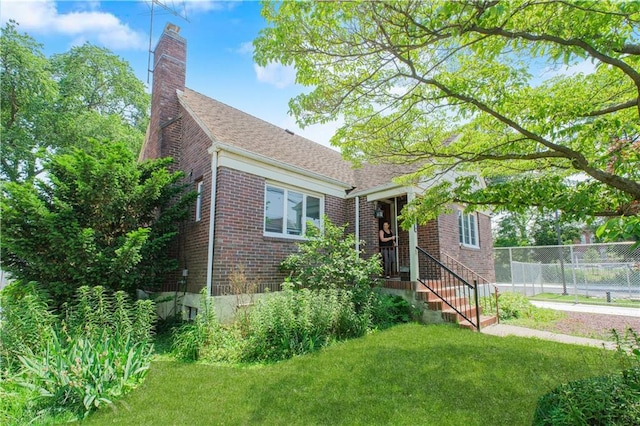 4070 Victory Blvd, Staten Island, NY 10314 - view of front of home with brick siding, a chimney, and a shingled roof