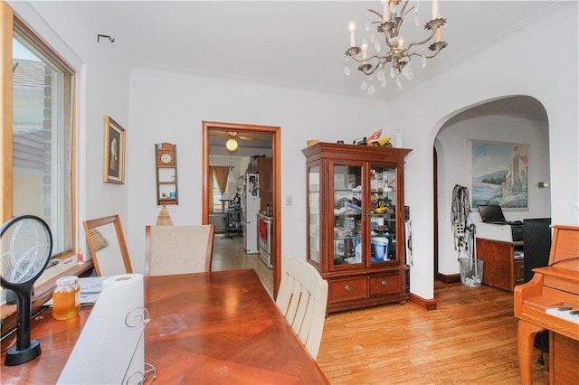4070 Victory Blvd, Staten Island, NY 10314 - dining space with arched walkways, light wood-style floors, crown molding, and a chandelier