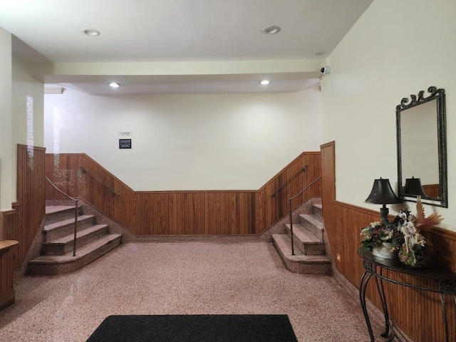 2251 Plumb St Unit 6B, Brooklyn, NY 11229 - stairway with a wainscoted wall, wood walls, and recessed lighting