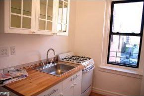 9524 Fort Hamilton Pkwy Unit 601, Brooklyn, NY 11209 - kitchen featuring white range with gas stovetop, glass insert cabinets, and white cabinetry
