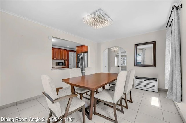 2160 E 36th St, Brooklyn, NY 11234 - dining space featuring arched walkways, light tile patterned floors, and crown molding