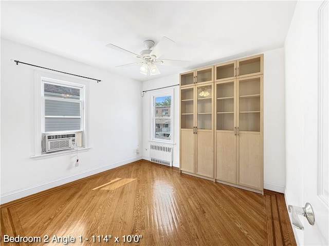 2160 E 36th St, Brooklyn, NY 11234 - unfurnished room with radiator, cooling unit, wood finished floors, and ceiling fan
