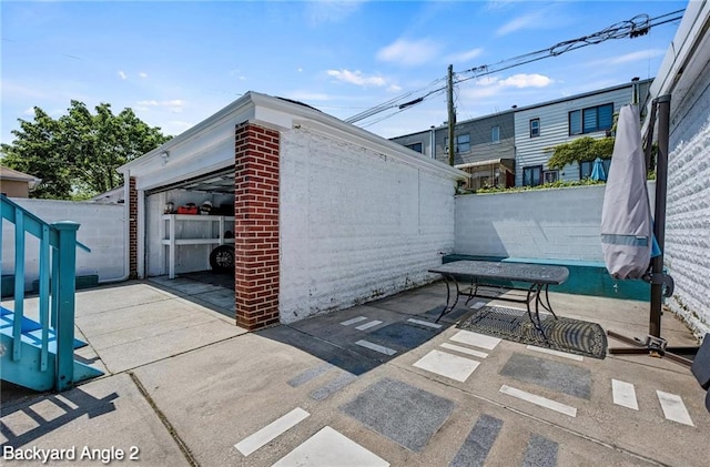 2160 E 36th St, Brooklyn, NY 11234 - view of patio featuring an outbuilding and a detached garage