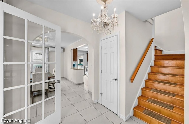 2160 E 36th St, Brooklyn, NY 11234 - staircase with arched walkways, tile patterned flooring, a wall mounted air conditioner, and a chandelier