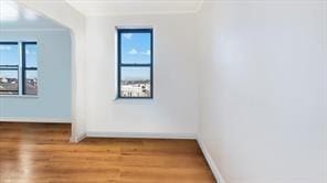 128-11 Newport Ave Unit 4C, Queens, NY 11694 - empty room with healthy amount of natural light, wood finished floors, and crown molding