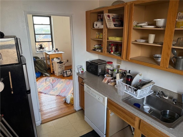 128-11 Newport Ave Unit 4C, Queens, NY 11694 - kitchen with dishwasher, freestanding refrigerator, open shelves, and light countertops
