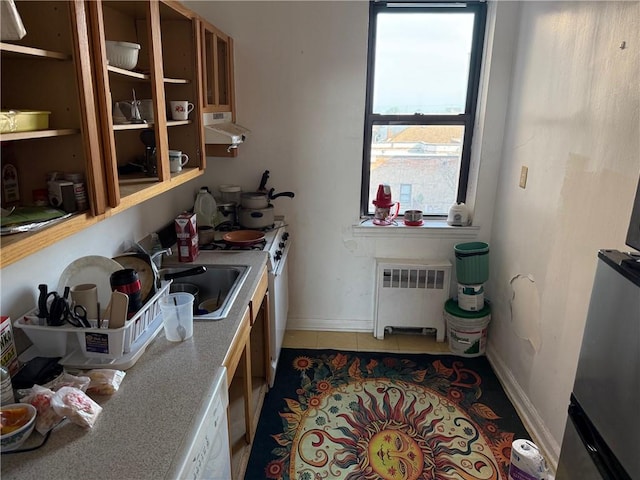 128-11 Newport Ave Unit 4C, Queens, NY 11694 - kitchen featuring radiator heating unit, under cabinet range hood, healthy amount of natural light, and tile patterned flooring