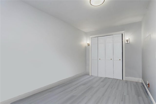 675 Ocean Ave Unit 5J, Long Branch, New Jersey, NJ 07740 - unfurnished bedroom featuring light wood-style floors and a closet