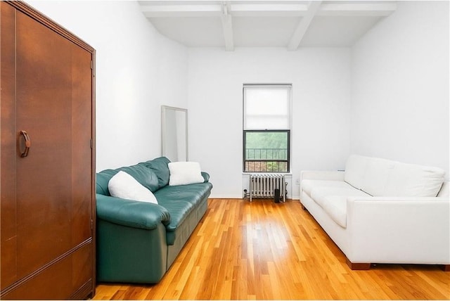 41 Jane St Unit 5B, New York, NY 10014 - sitting room featuring radiator heating unit, beamed ceiling, and light wood-style floors