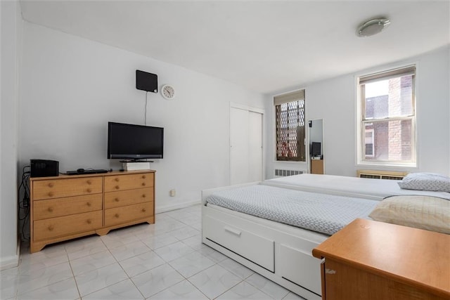 735 Avenue W Unit 6J, Brooklyn, NY 11223 - bedroom featuring light marble finish flooring, radiator heating unit, and a closet