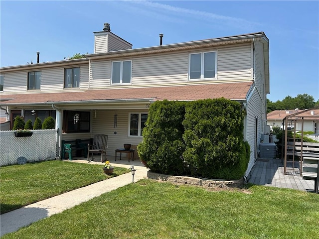 30 Regis Dr Unit 76, Staten Island, NY 10314 - rear view of house featuring a yard, a chimney, and a patio area