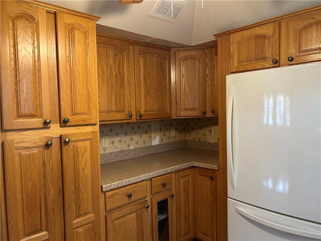 30 Regis Dr Unit 76, Staten Island, NY 10314 - kitchen with freestanding refrigerator, brown cabinetry, and light countertops