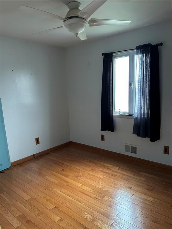 30 Regis Dr Unit 76, Staten Island, NY 10314 - empty room featuring ceiling fan and light wood-type flooring